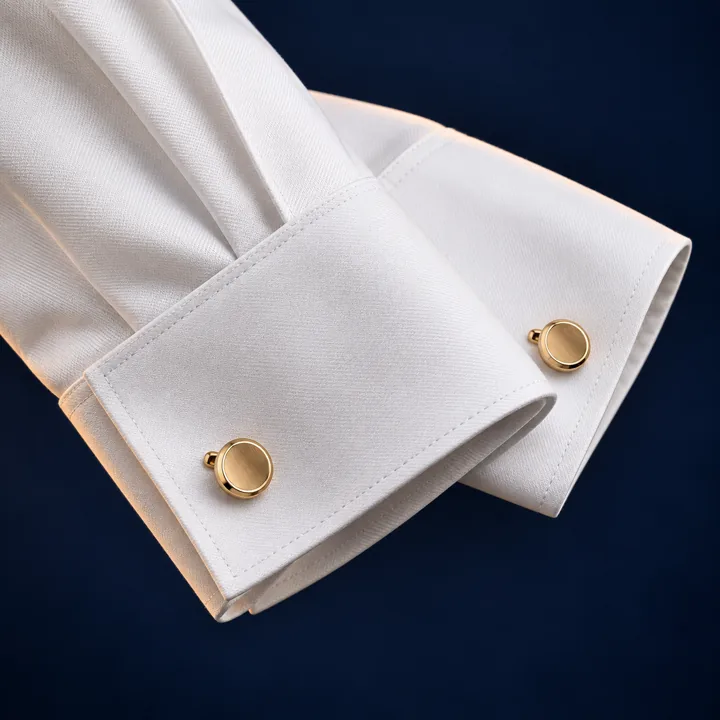 Folded white French cuffs with gold cufflinks